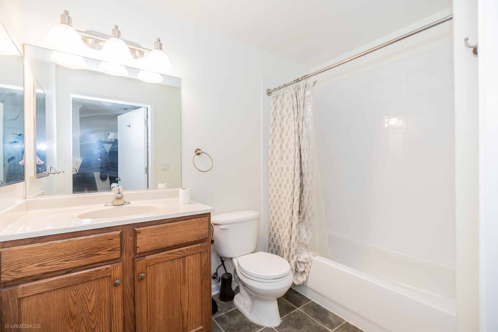 100 North Hermitage Avenue, Unit 716 Chicago, IL 60612 - Photo 14 of 25 a bathroom with a sink a toilet and a mirror