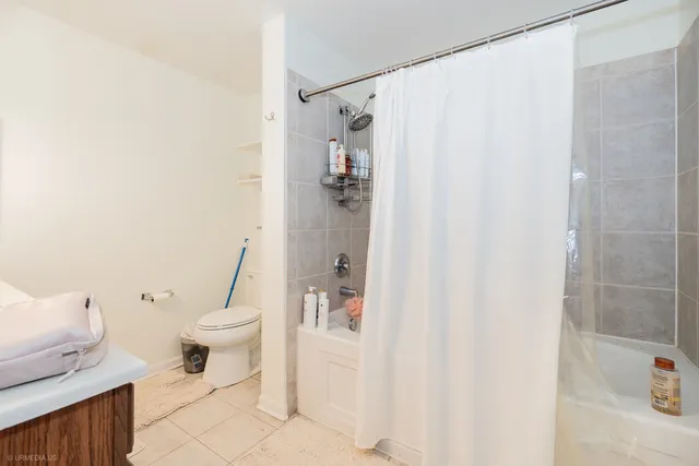 a bathroom with a sink vanity mirror and toilet