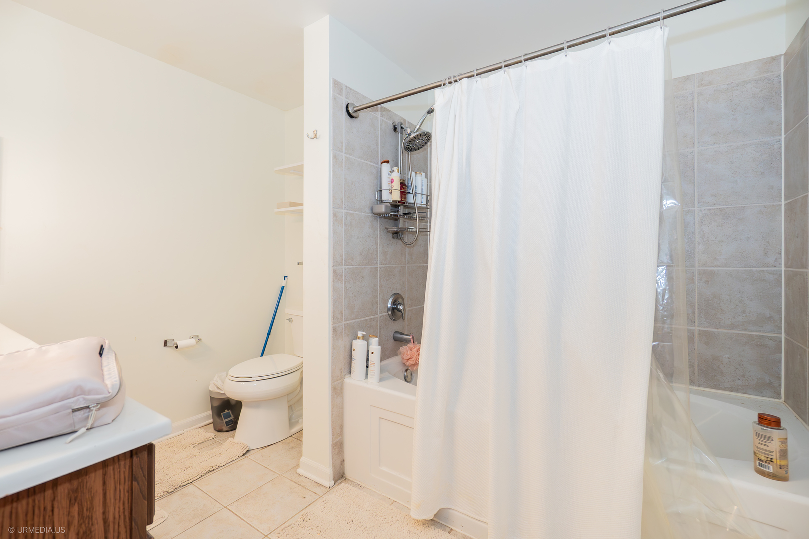 100 North Hermitage Avenue, Unit 716 Chicago, IL 60612 - Photo 15 of 25 a white toilet sitting next to a bathroom sink