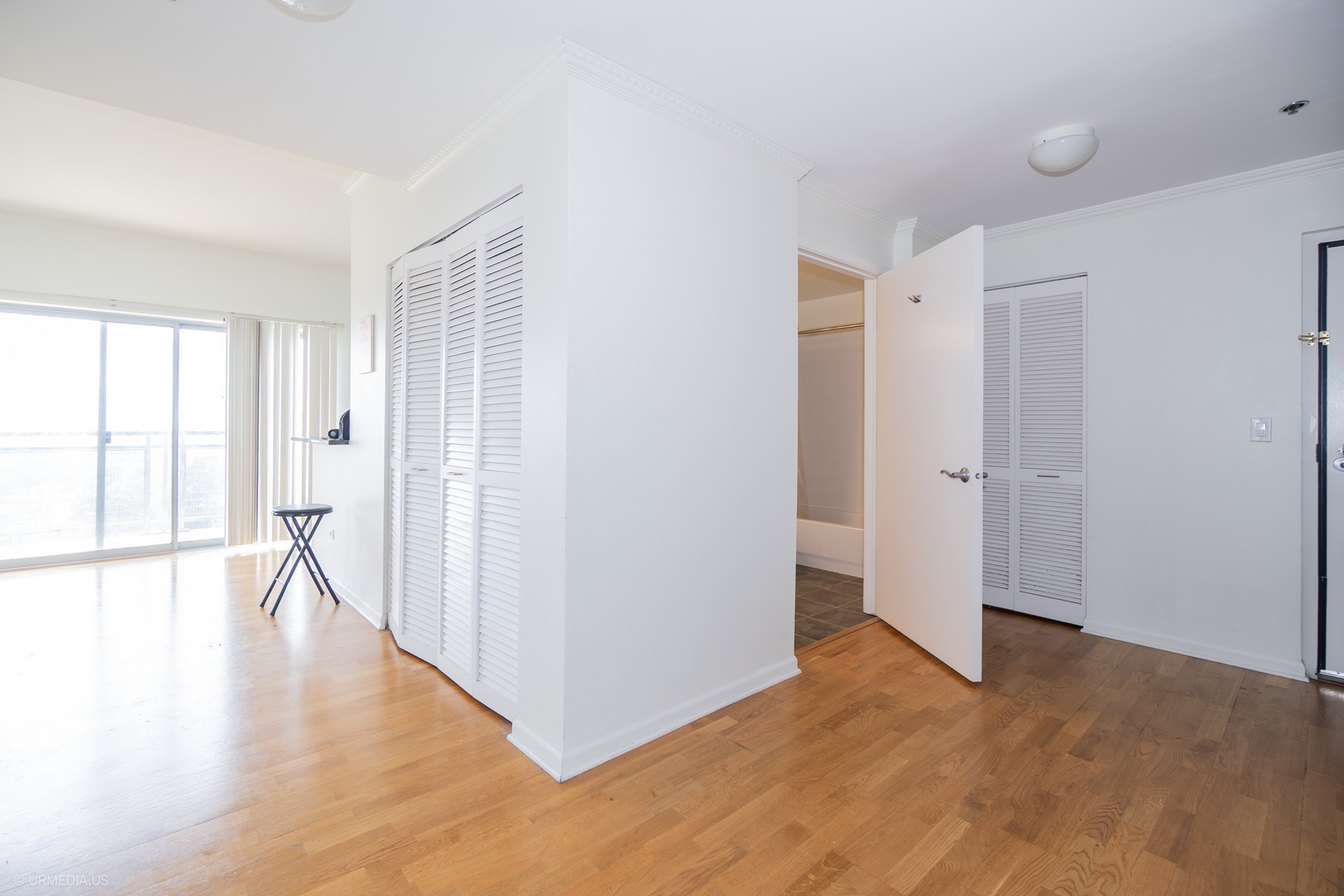 100 North Hermitage Avenue, Unit 716 Chicago, IL 60612 - Photo 21 of 25 a view of an empty room with wooden floor and a window