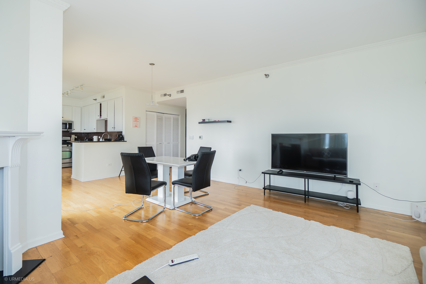 100 North Hermitage Avenue, Unit 716 Chicago, IL 60612 - Photo 3 of 25 a living room with furniture and a flat screen tv