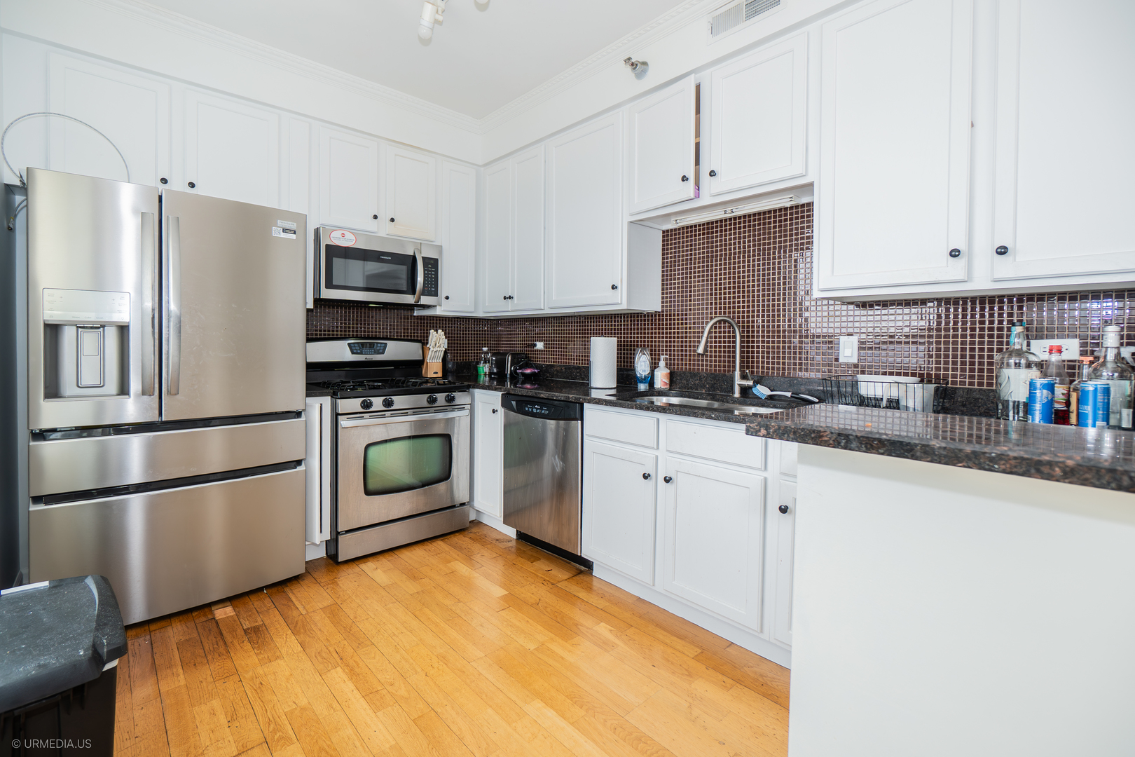 100 North Hermitage Avenue, Unit 716 Chicago, IL 60612 - Photo 10 of 25 a kitchen with granite countertop a white stove top oven and refrigerator