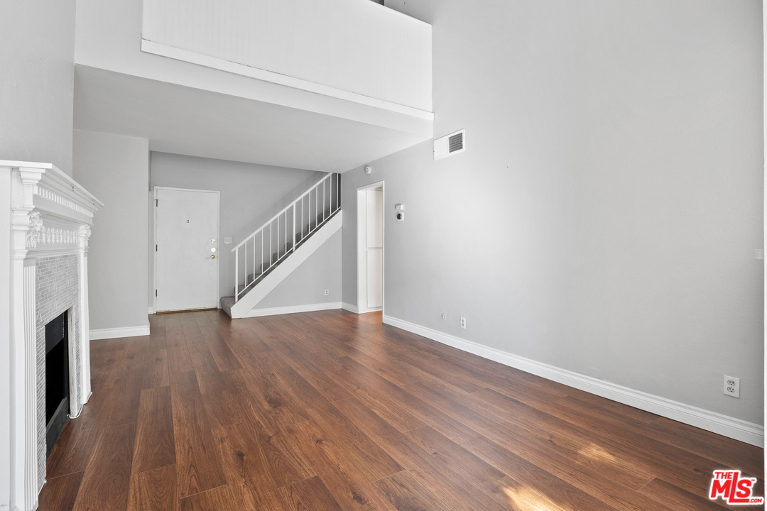 9302 Summertime Lane Culver City, CA 90230 - Photo 12 of 26 a view of an empty room with wooden floor and a fireplace