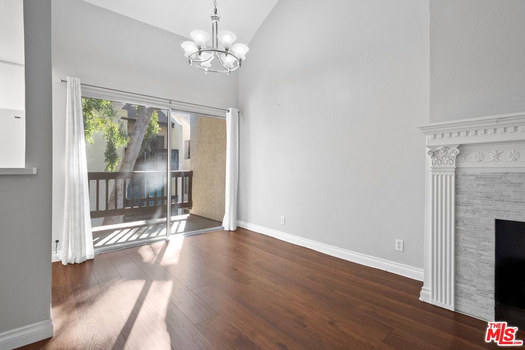 9302 Summertime Lane Culver City, CA 90230 - Photo 13 of 26 a view of a room with wooden floor fireplace and windows