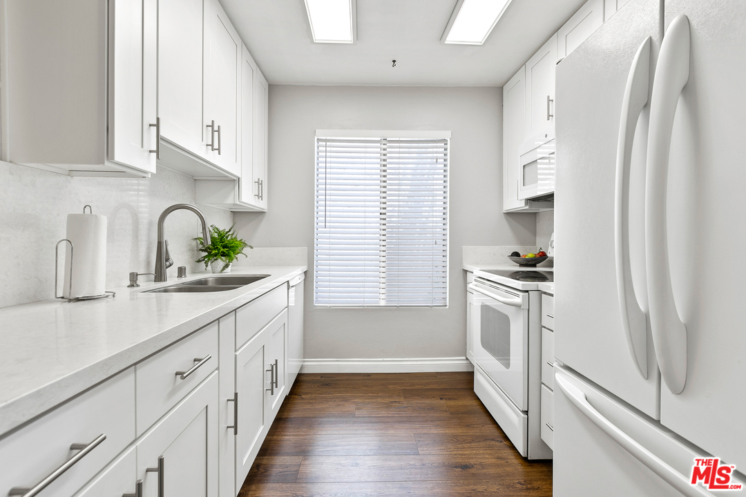 9302 Summertime Lane Culver City, CA 90230 - Photo 6 of 26 a kitchen with white cabinets and appliances