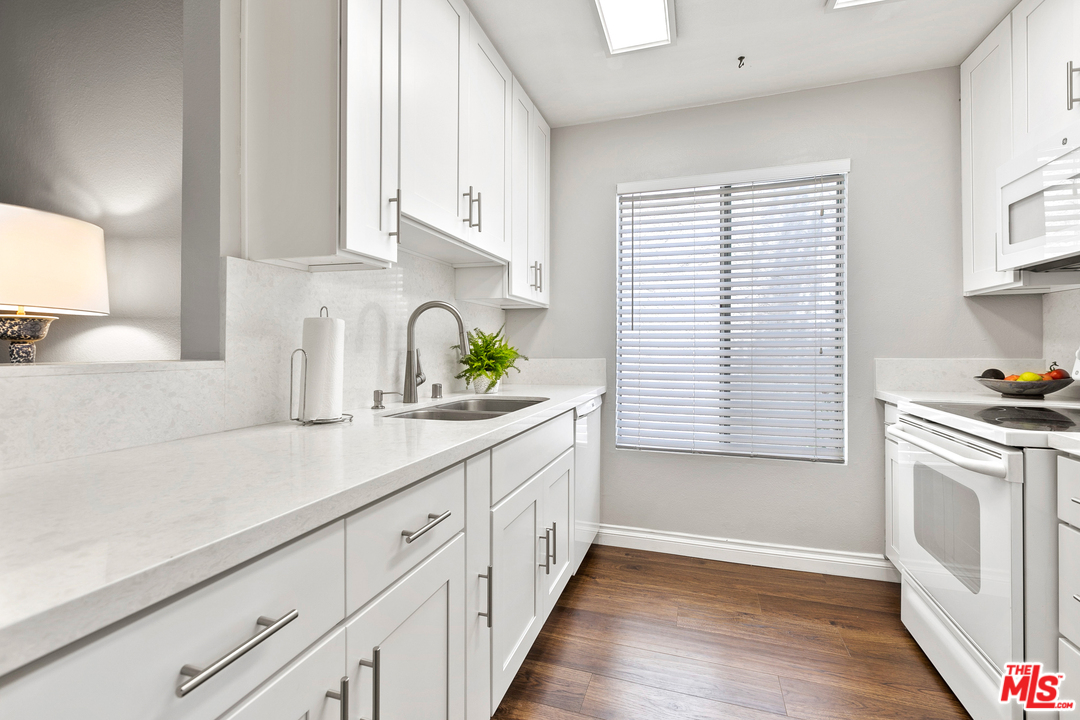 9302 Summertime Lane Culver City, CA 90230 - Photo 7 of 26 a kitchen with white cabinets and white appliances
