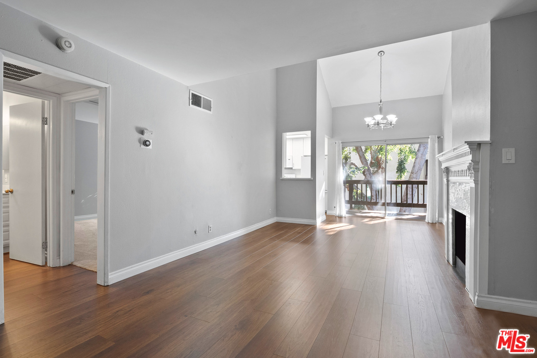 9302 Summertime Lane Culver City, CA 90230 - Photo 9 of 26 an empty room with wooden floor and a fireplace