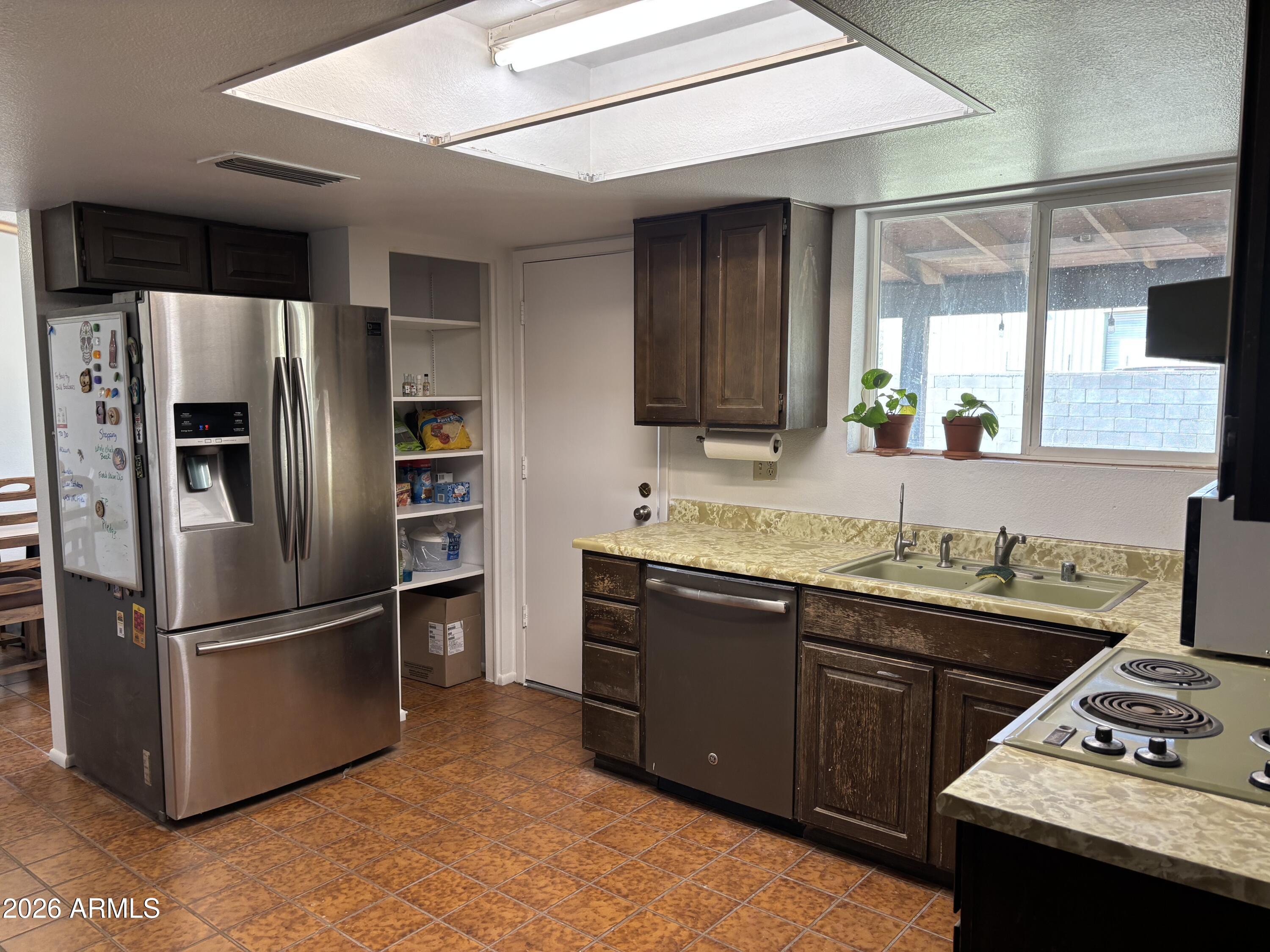 6508 West Fremont Road Laveen, AZ 85339 - Photo 10 of 32 a kitchen with stainless steel appliances granite countertop a refrigerator and a sink