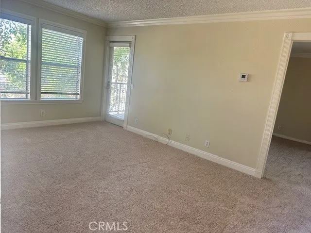 an empty room with windows and closet
