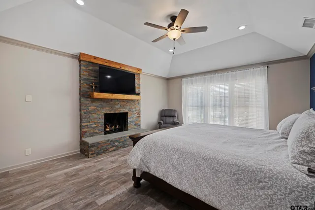 a spacious bedroom with a bed and a fireplace