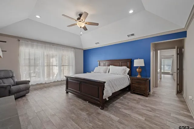 a bedroom with a bed couch and window