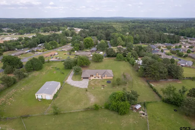 an aerial view of a house with a yard