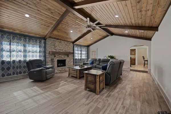 a kitchen with stainless steel appliances granite countertop a stove a sink dishwasher a microwave oven and a refrigerator with wooden floor