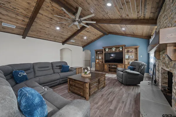 a spacious bedroom with a bed and a fireplace