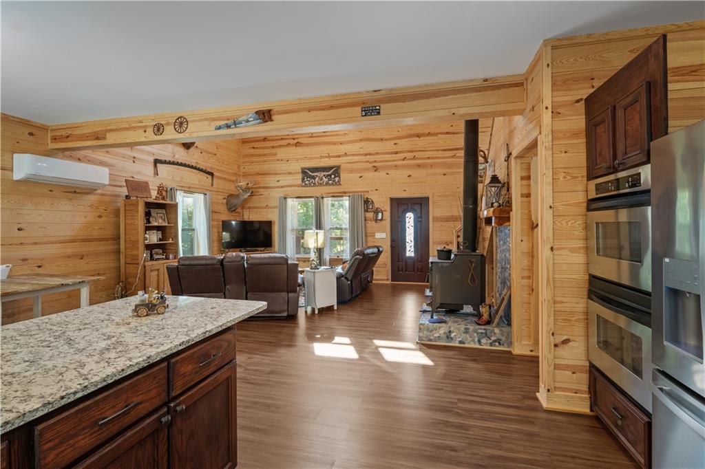661 Wildcat Road Buchanan, GA 30113 - Photo 26 of 51 a living room with stainless steel appliances kitchen island granite countertop wooden floor and a sink