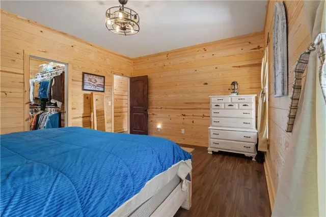a bathroom with a granite countertop sink a mirror and shower
