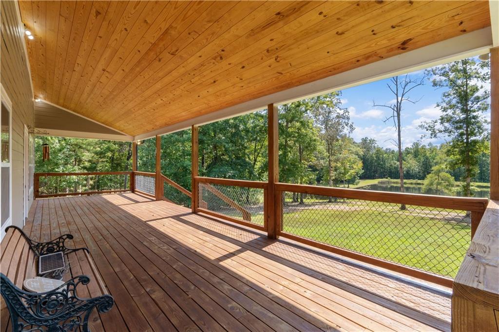 661 Wildcat Road Buchanan, GA 30113 - Photo 9 of 51 a view of a large pool with a large window and lawn chairs