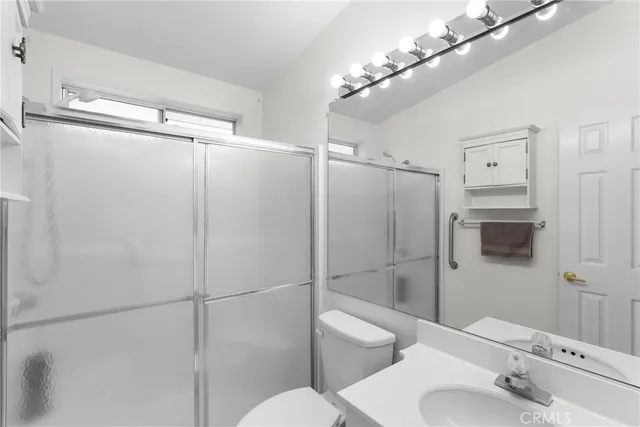 a bathroom with a toilet sink and shower