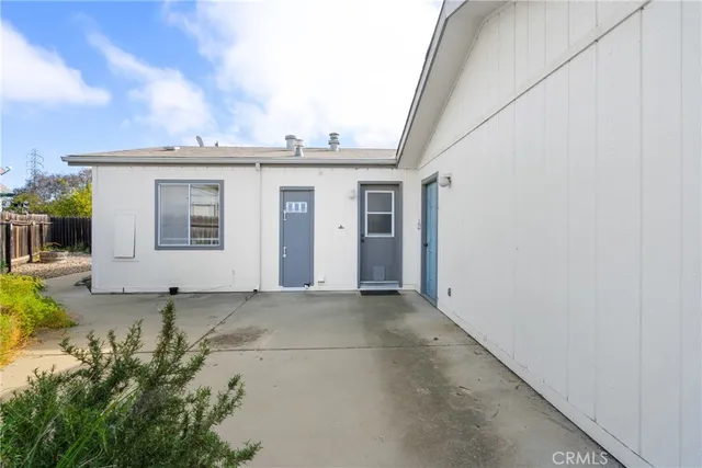 a view of a house with a white wall and door