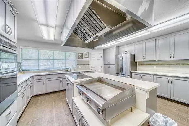 a kitchen with a stove sink and cabinets