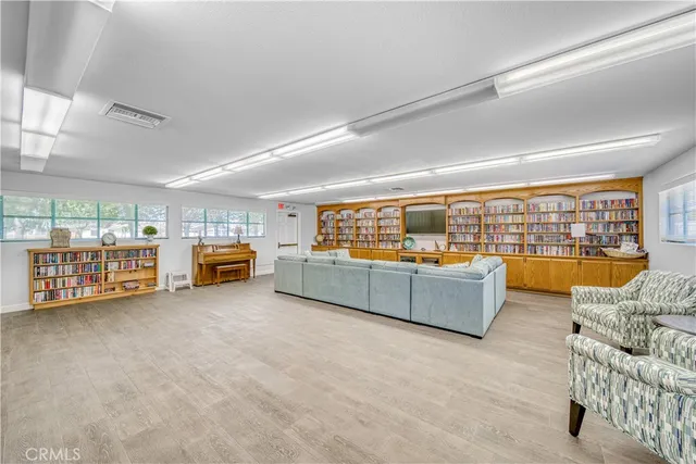 a view of a living room with furniture and kitchen view