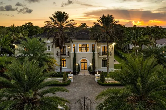 a front view of multi story residential apartment building with yard and green space