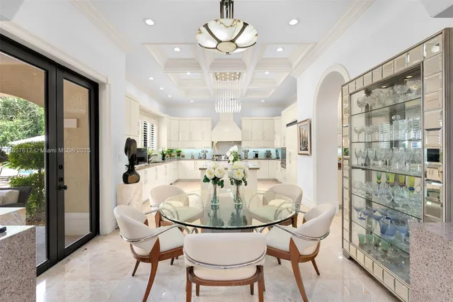 a kitchen with stainless steel appliances a stove a sink and white cabinets