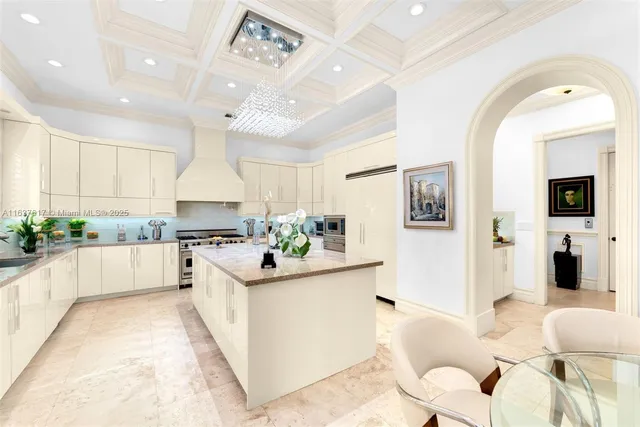a large white kitchen with lots of counter top space and appliances