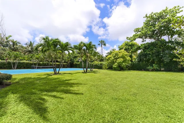 a view of a house with pool and chairs