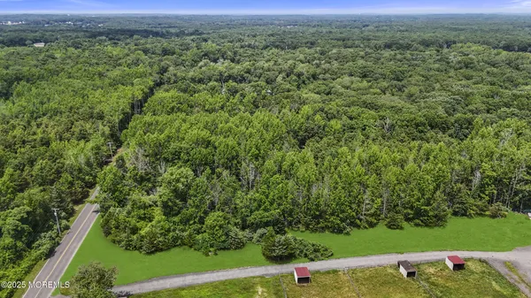 an aerial view of a houses with a yard