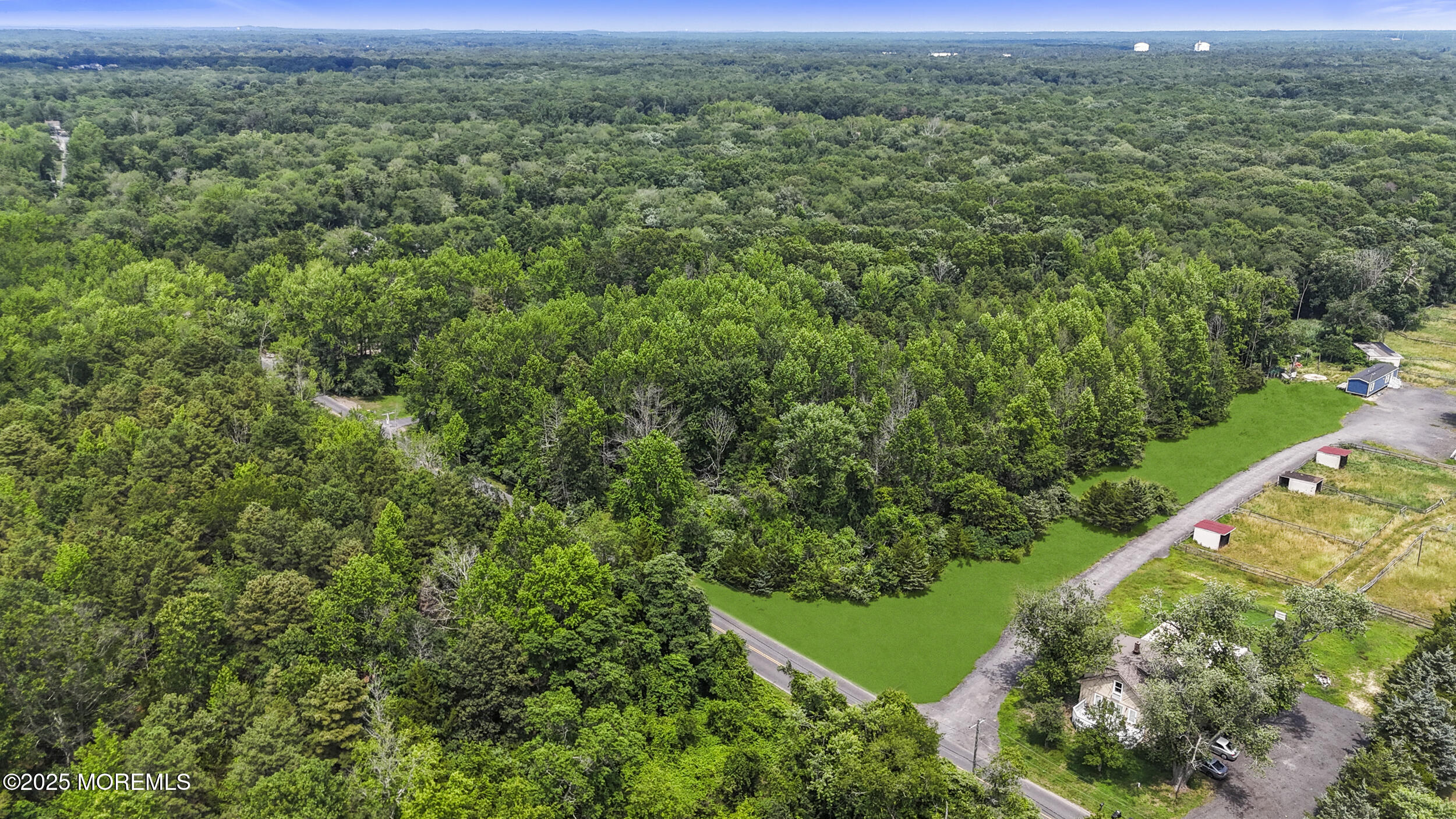 1070 Maxim Southard Road Howell, NJ 07731 - Photo 6 of 9 a view of a lush green forest with a street