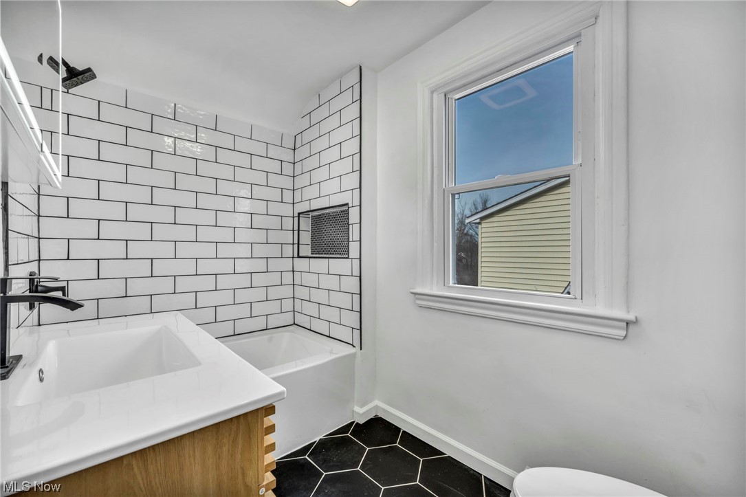 932 Englewood Road Cleveland Heights, OH 44121 - Photo 21 of 32 Full bathroom featuring tile floors, tiled shower / bath, vanity, and toilet