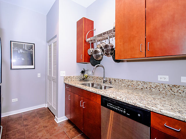 1155 West Roosevelt Road, Unit 409 Chicago, IL 60608 - Photo 9 of 16 a bathroom with a sink and a mirror
