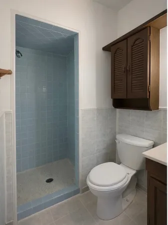 a bathroom with a toilet and a shower
