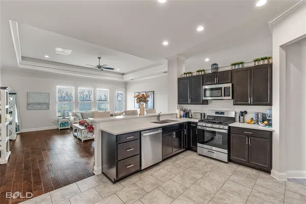 a kitchen with a sink stove and microwave