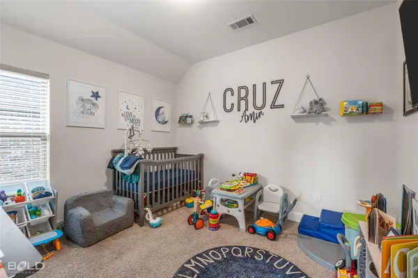 a bedroom with furniture and a book shelf