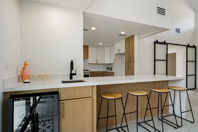 a kitchen with stainless steel appliances granite countertop a stove a sink and a refrigerator