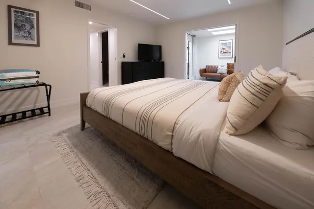 a bedroom with a bed and a lamp