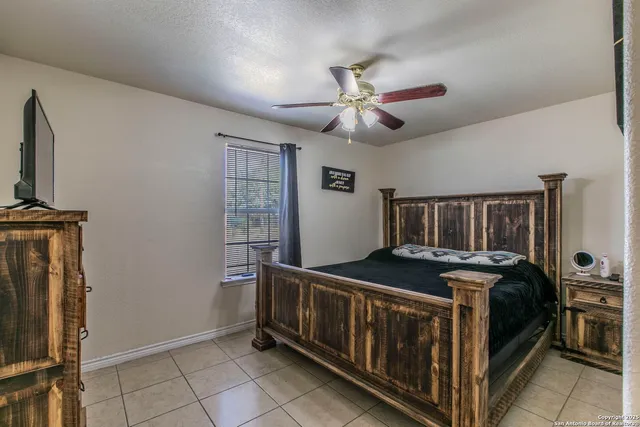 a bedroom with furniture and a chandelier