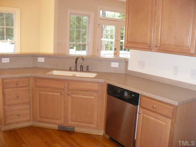 1109 Silas Ridge Court Raleigh, NC 27609 - Photo 7 of 23 a kitchen with a sink cabinets appliances and a window