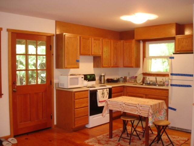 19-4031 Haunani Road Volcano, HI 96785 - Photo 3 of 21 a kitchen with a stove a sink and a refrigerator