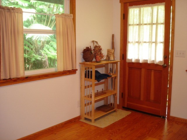 19-4031 Haunani Road Volcano, HI 96785 - Photo 6 of 21 a view of a room with wooden floor and windows
