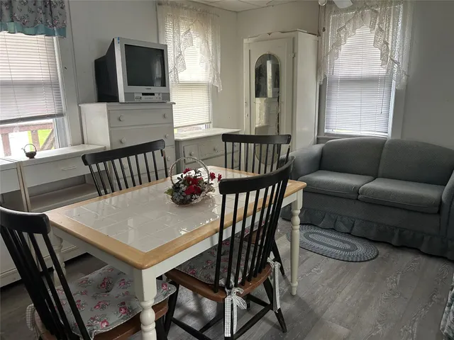 a view of a livingroom with furniture and a window