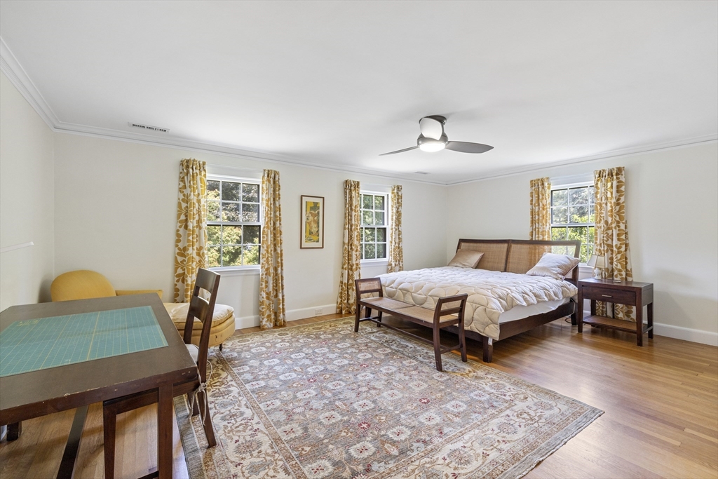 208 Rutledge Road Belmont, MA 02478 - Photo 19 of 34 a bedroom with a bed a table and chair