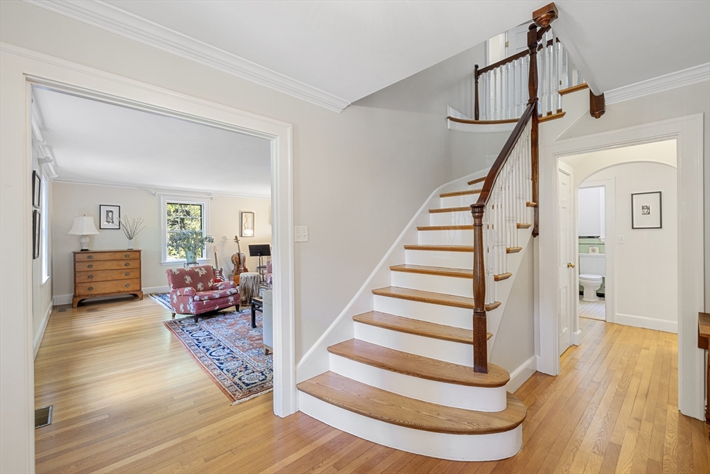 208 Rutledge Road Belmont, MA 02478 - Photo 2 of 34 a view of staircase with white walls and wooden floor