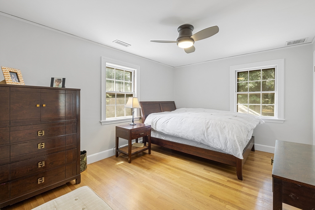 208 Rutledge Road Belmont, MA 02478 - Photo 21 of 34 a bedroom with a bed and a chandelier