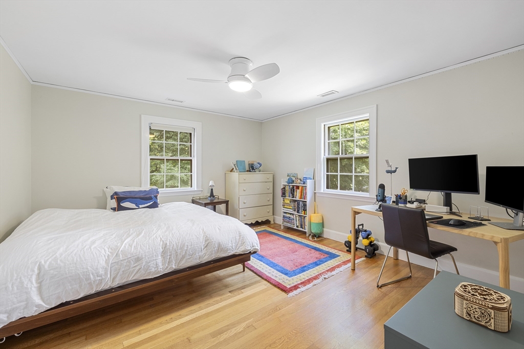 208 Rutledge Road Belmont, MA 02478 - Photo 24 of 34 a bedroom with a bed a large window and a flat screen tv