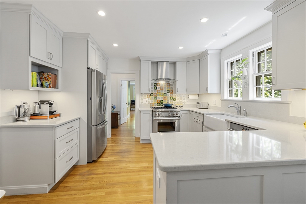 208 Rutledge Road Belmont, MA 02478 - Photo 3 of 34 a kitchen with white cabinets and stainless steel appliances