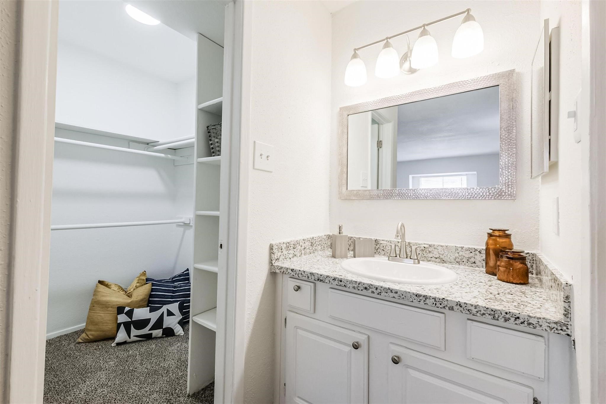 8162 Richmond Avenue, Unit 2210 Houston, TX 77063 - Photo 14 of 33 a en suite bathroom with a granite countertop sink and a mirror