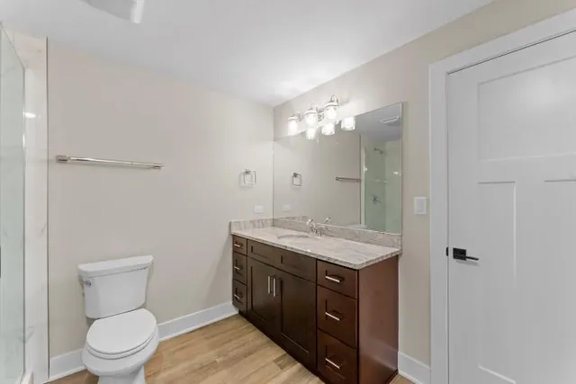 a white toilet sitting next to a bathroom sink